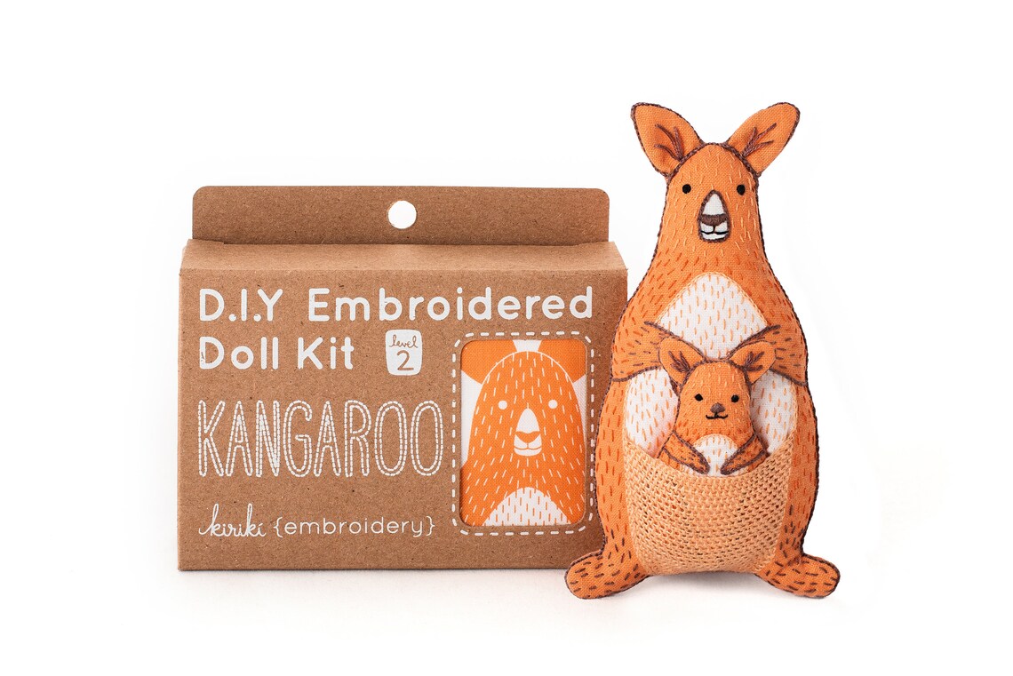 Kangaroo-shaped embroidered doll kit with packaging on a white background