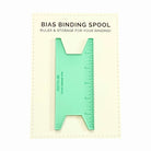 Green bias binding spool ruler on a white background