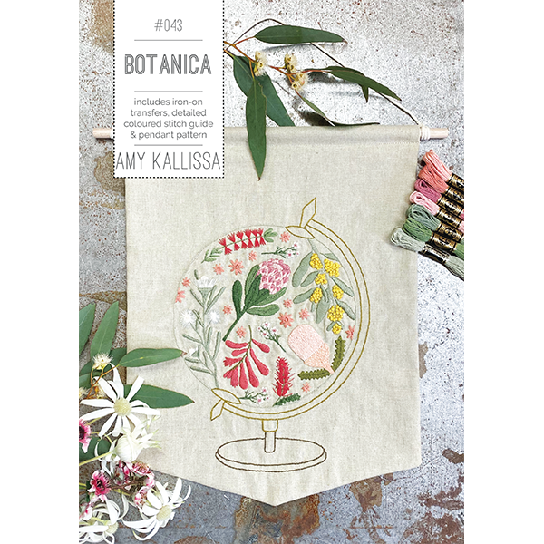 Embroidery kit with floral design and text 'Botanica' by Amy Kallissa on a textured surface.