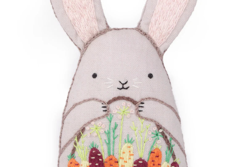 Embroidered bunny with garden design on a white background