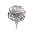 Decorative metal flower-shaped needle threader on a white background